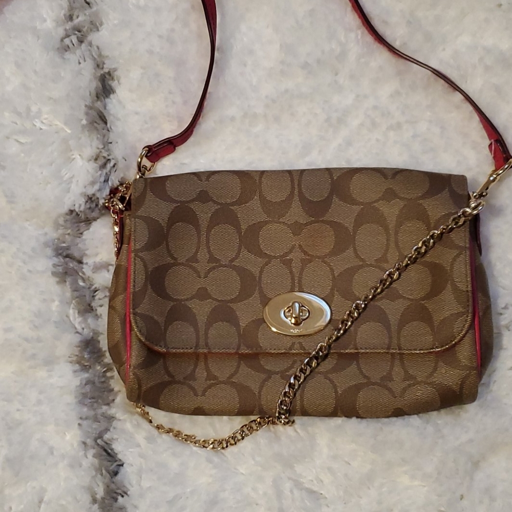 Coach crossbody with pink strap and trim.